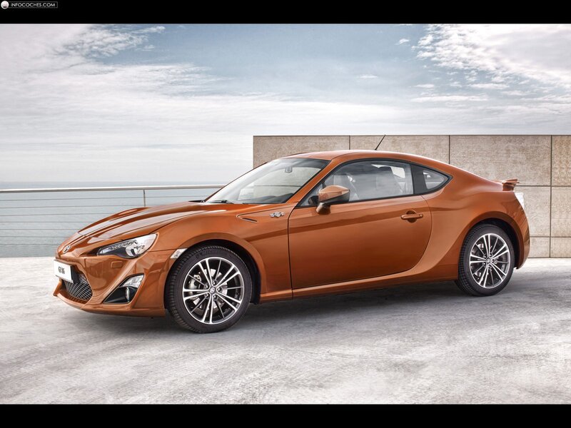 Orange sports coupe by the sea