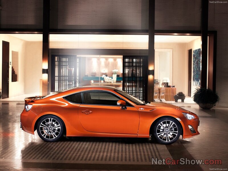 Orange sports coupe in showroom