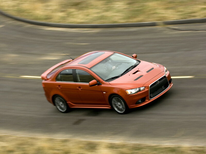 Orange sports sedan in motion
