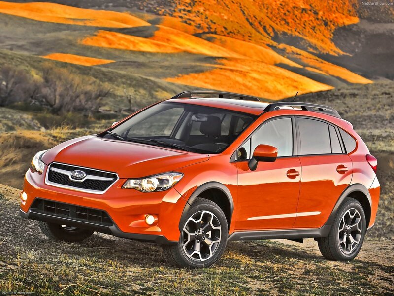 Orange Subaru XV in a scenic landscape