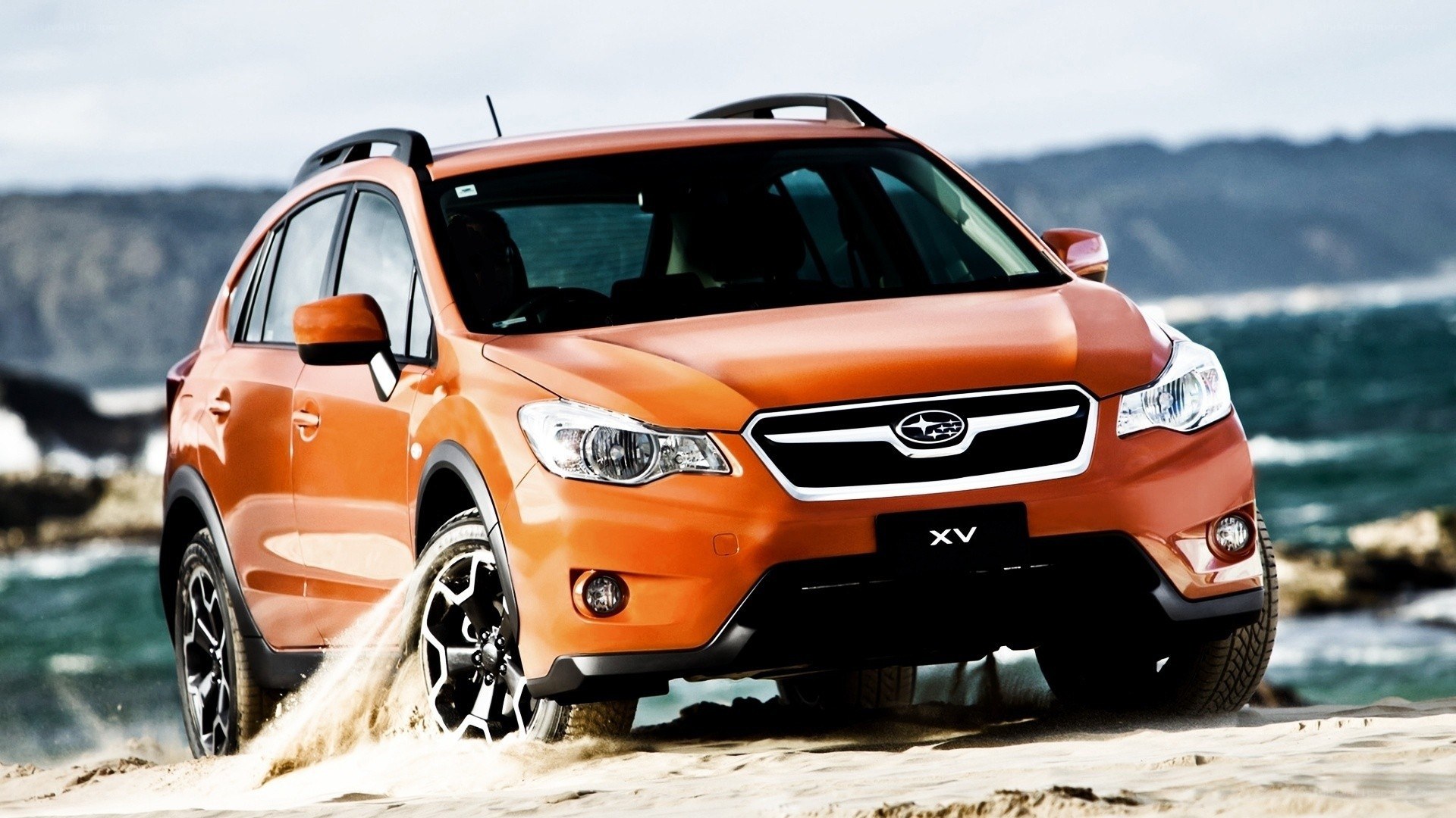Orange Subaru XV on beach