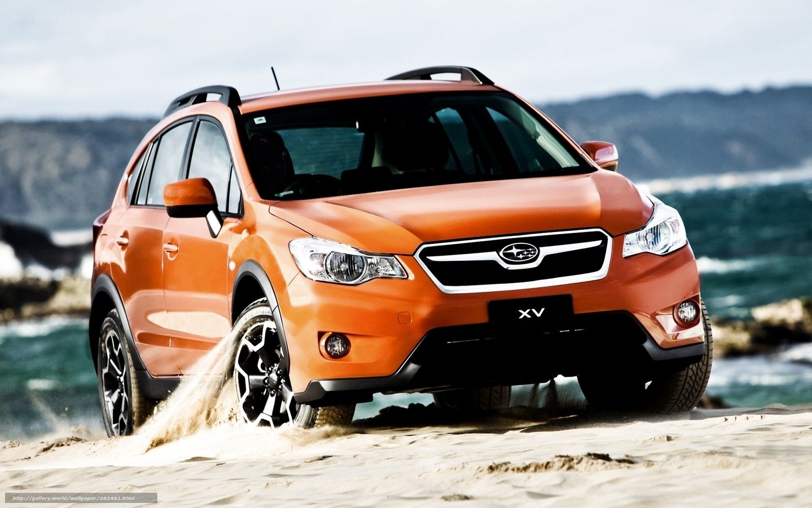 Orange Subaru XV on beach