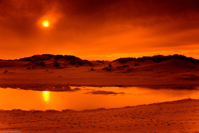 Orange sunset over dunes