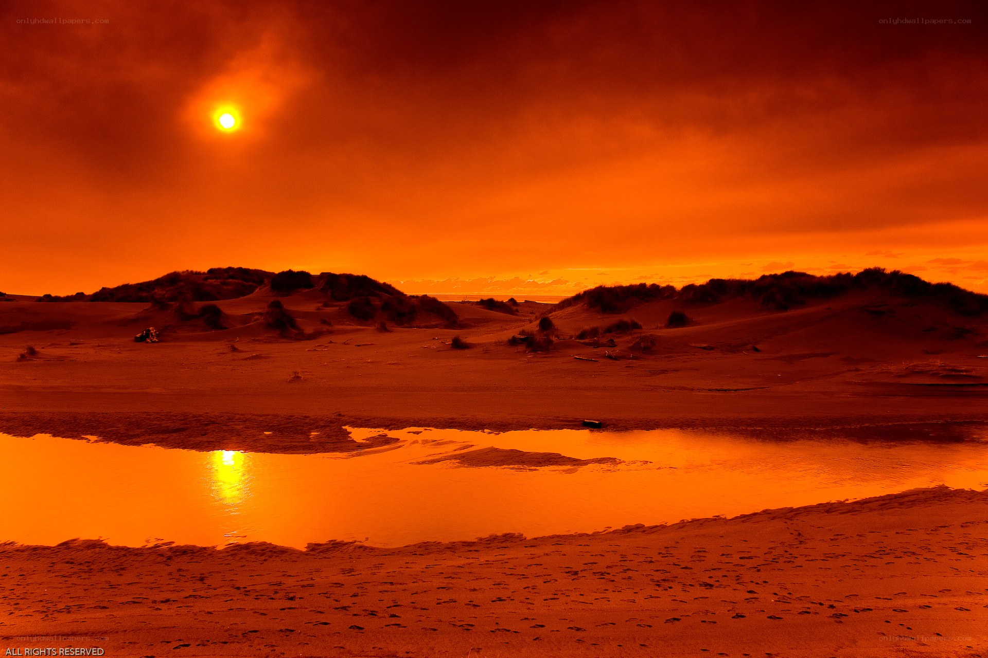 Orange sunset over dunes