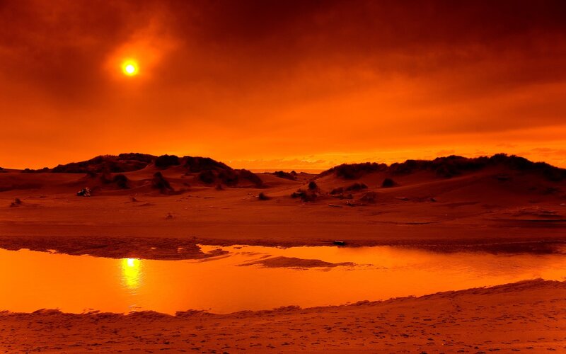 Orange sunset over dunes