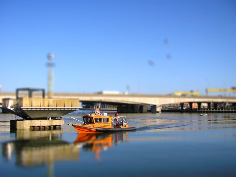 Orange survey boat on water