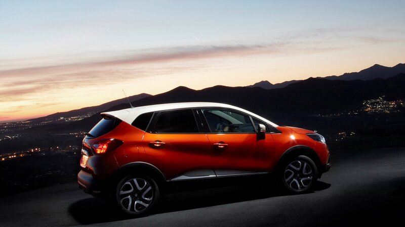 Orange SUV at dusk