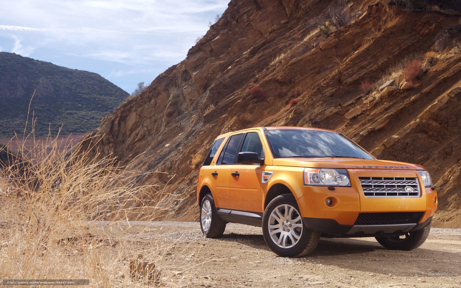 Orange SUV in a canyon