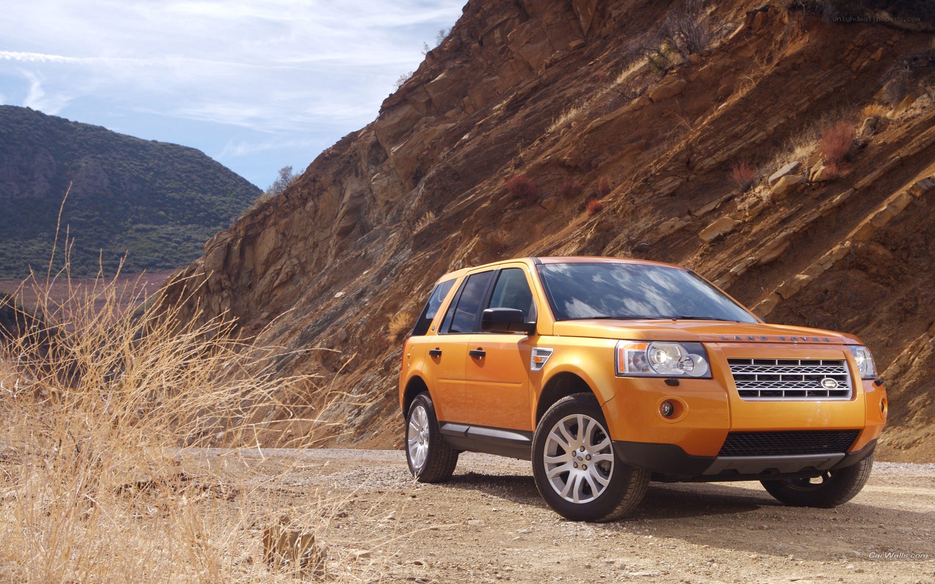Orange SUV on a dirt road