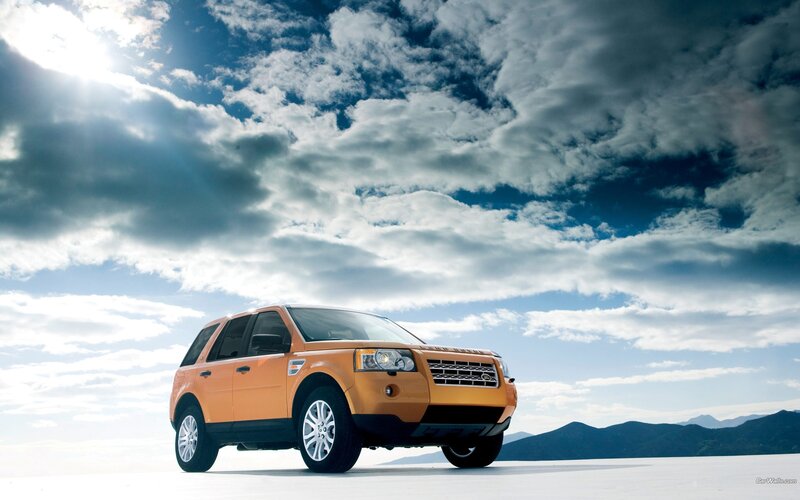 Orange SUV on a salt flat