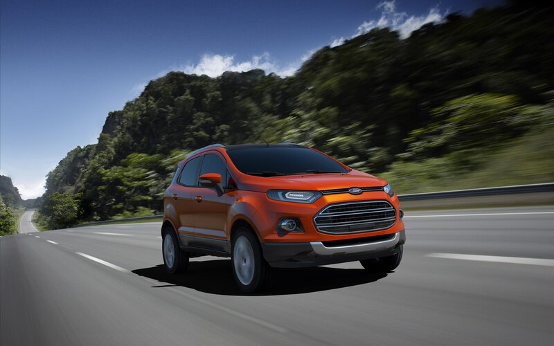 Orange SUV on a scenic road