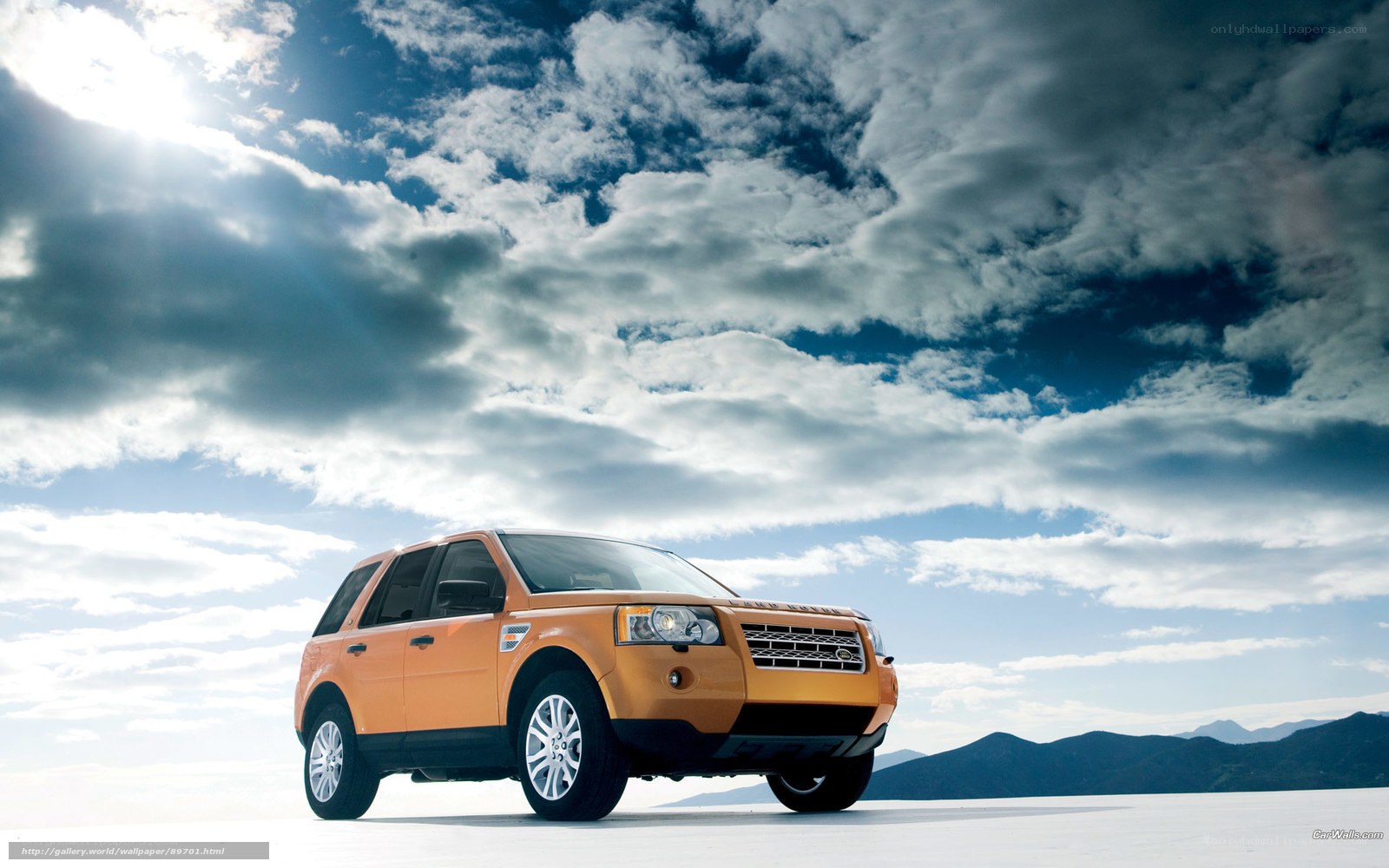 Orange SUV on desert plain