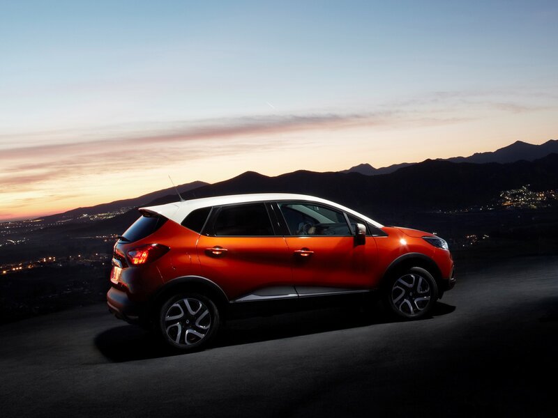Orange SUV on Road — Dramatic