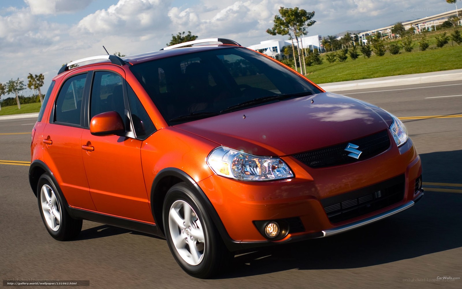 Orange Suzuki SX4 in motion