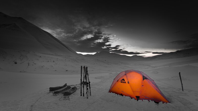 Orange tent in snowy landscape
