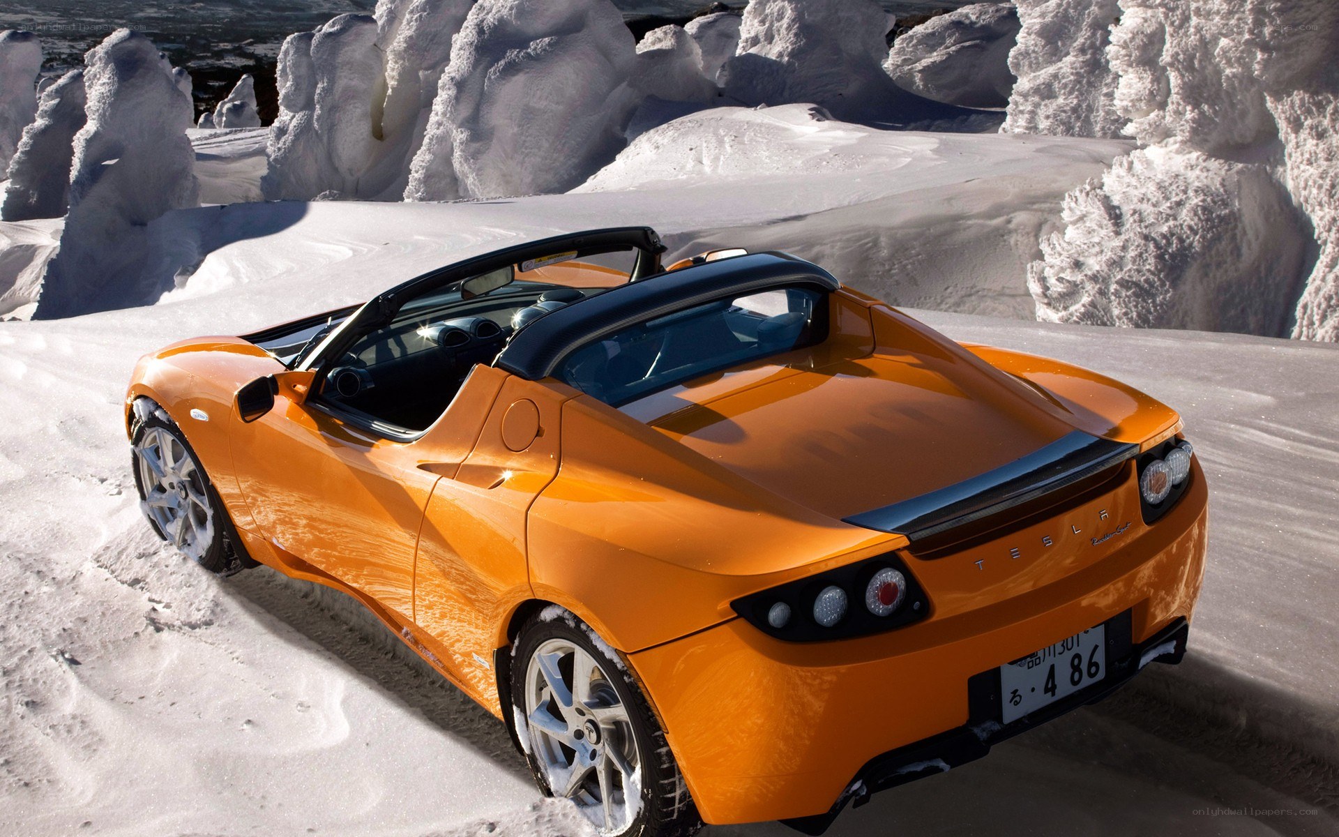 Orange Tesla Roadster in snow