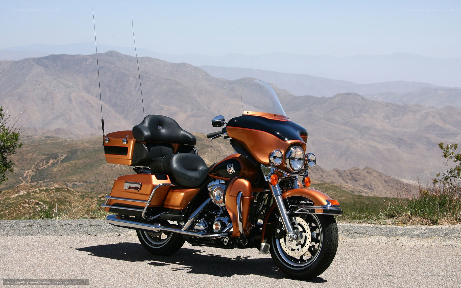 Orange touring motorcycle on mountain road