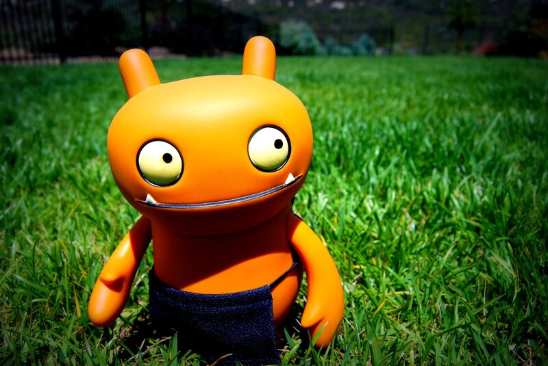 Orange toy figure in grass