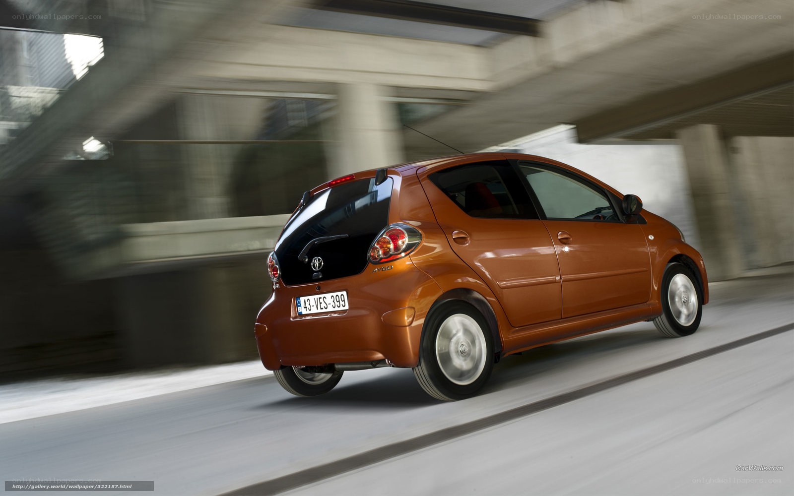 Orange Toyota Aygo in motion