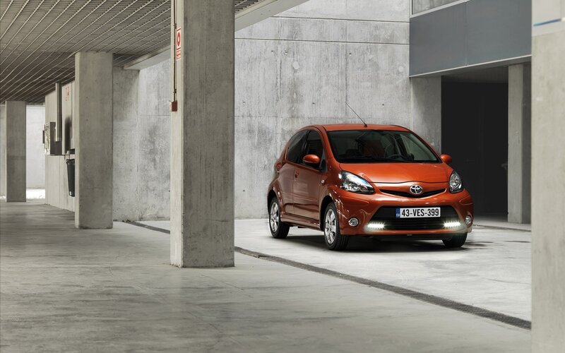 Orange Toyota Aygo in parking garage