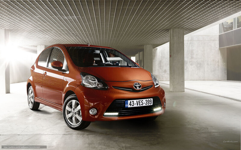 Orange Toyota Aygo in parking garage