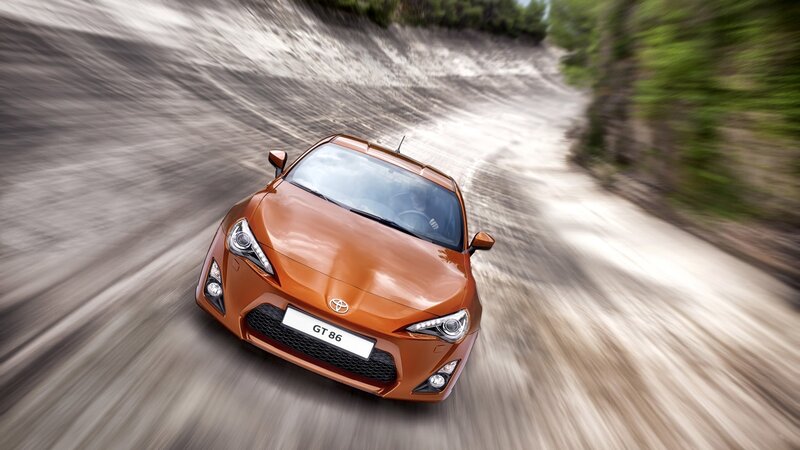Orange Toyota GT86 on a dirt road