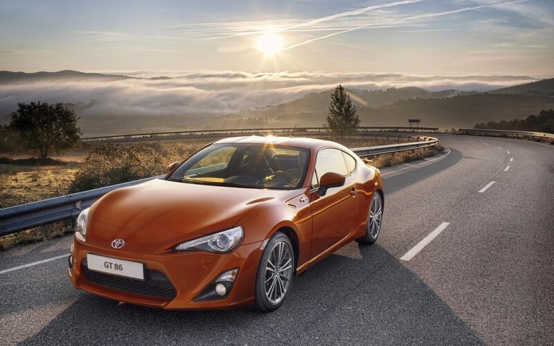 Orange Toyota GT86 on a winding road