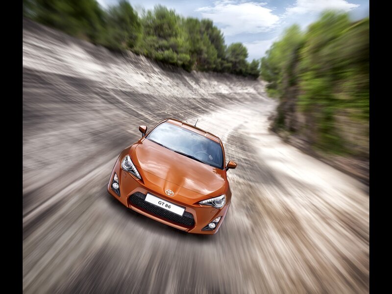 Orange Toyota GT86 on a winding road