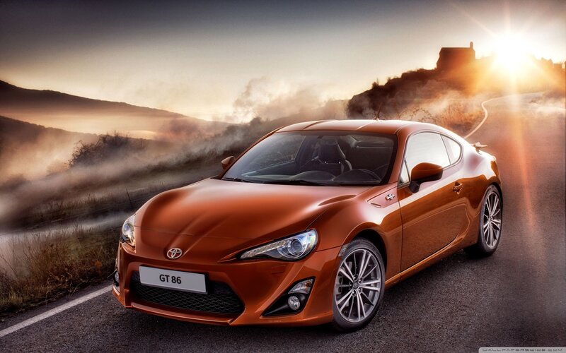 Orange Toyota GT86 on a winding road