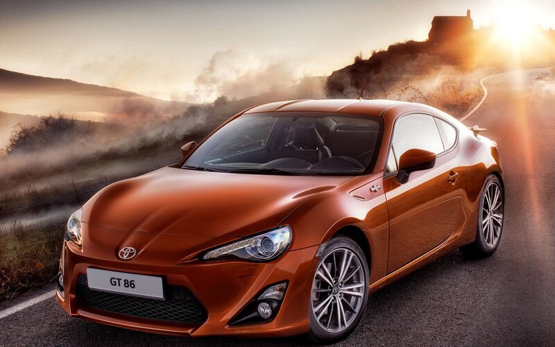 Orange Toyota GT86 on a winding road