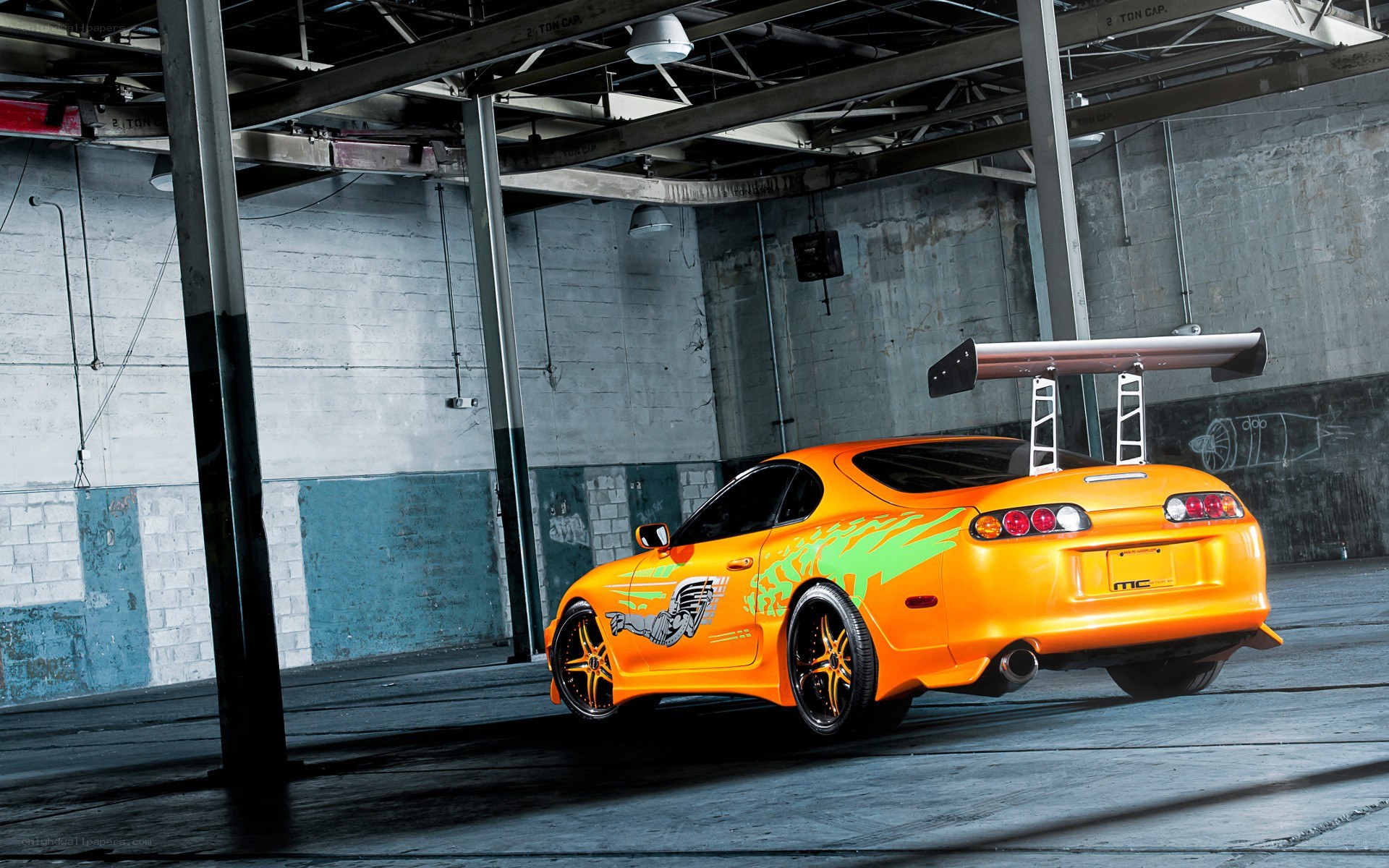 orange Toyota Supra in garage