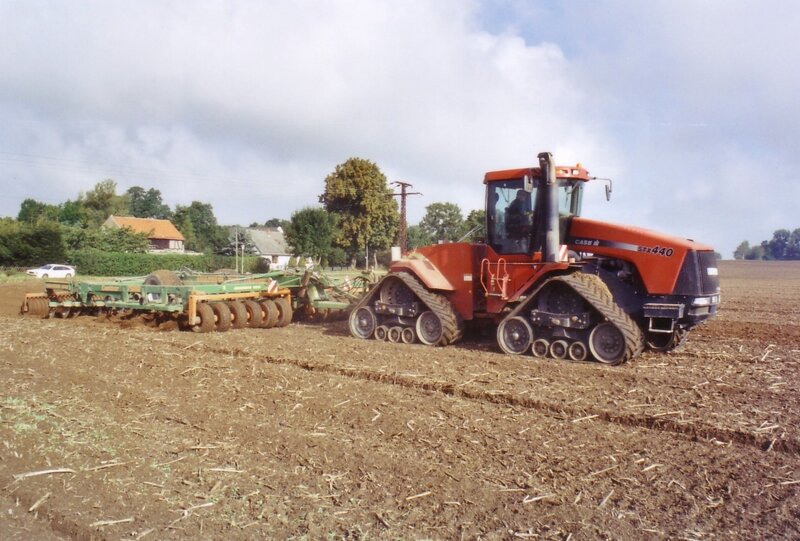 Orange Tractor Plowing Field
