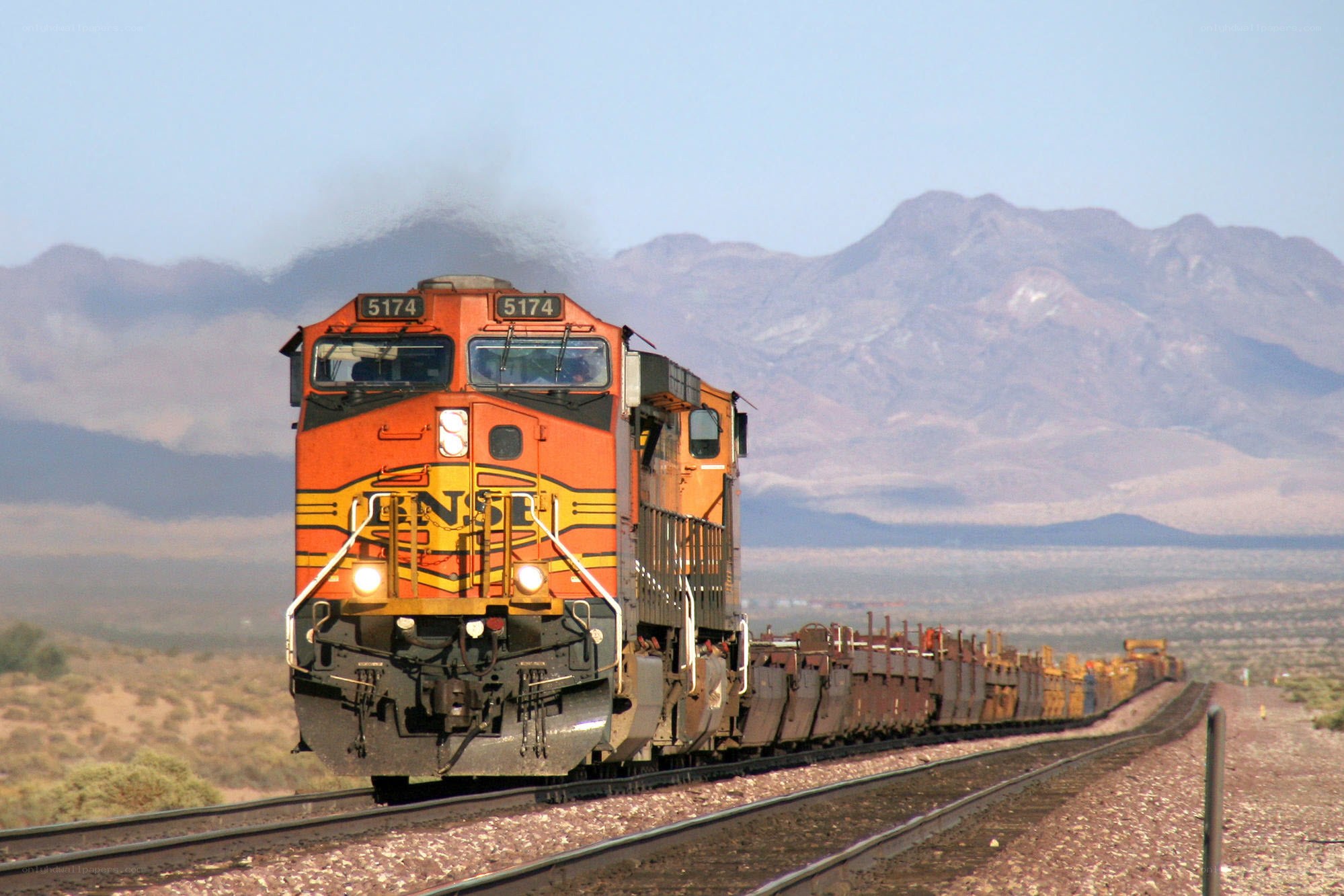 Orange train in desert landscape