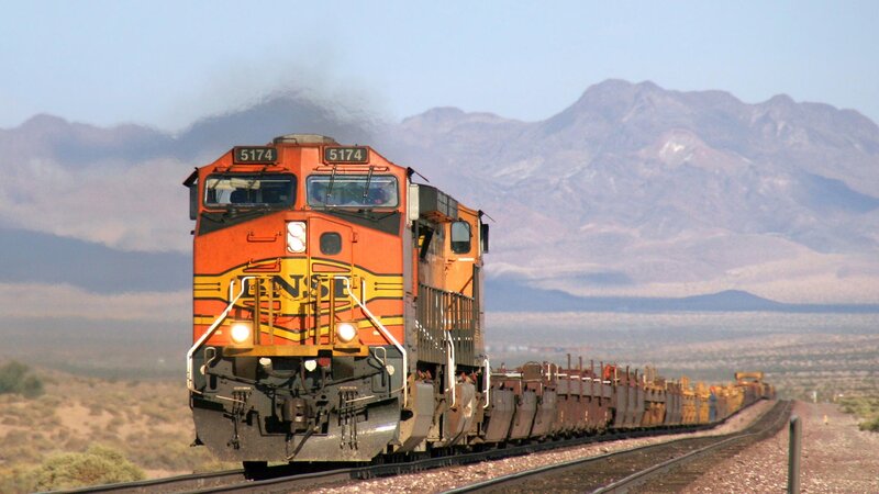 Orange train in desert landscape