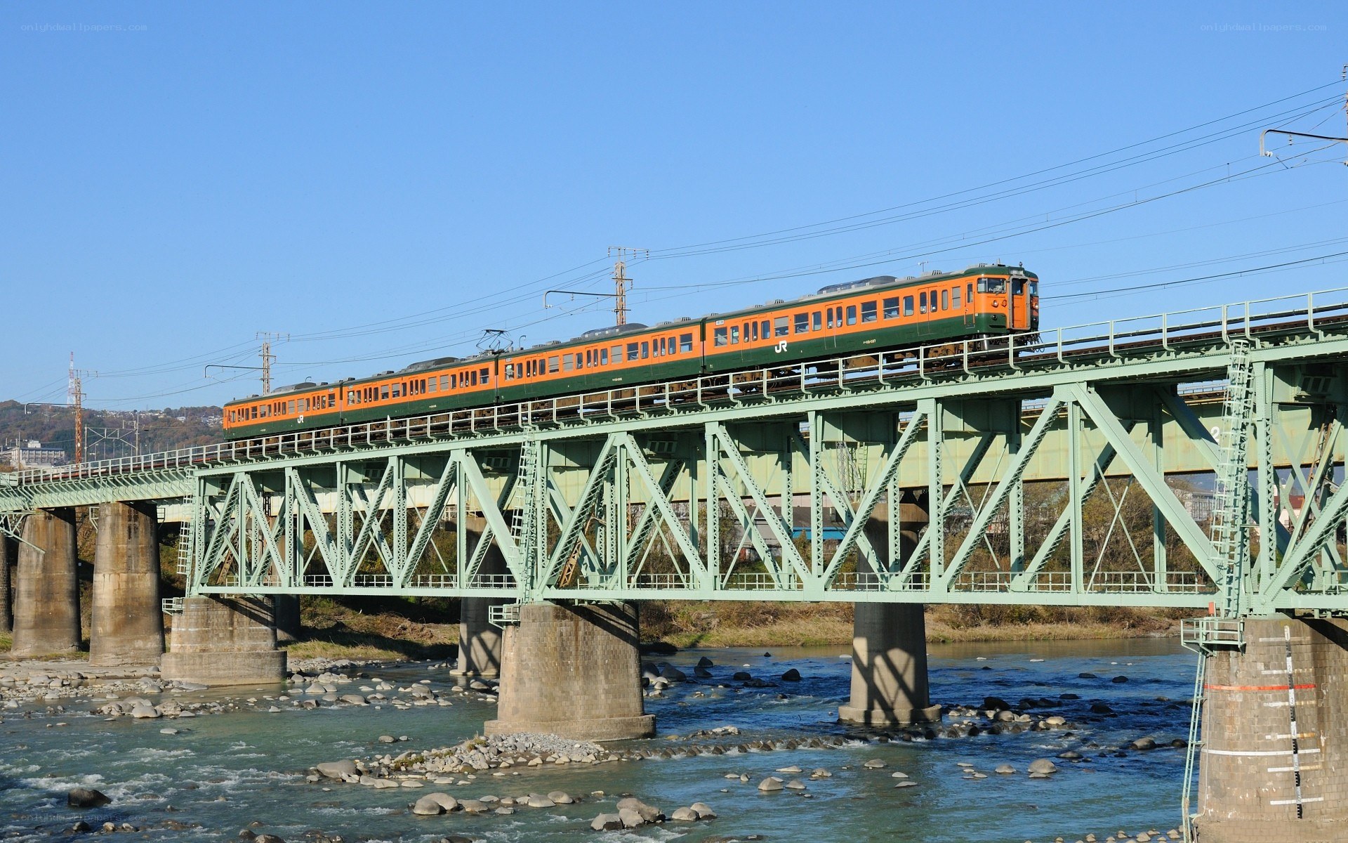 Orange train on green bridge