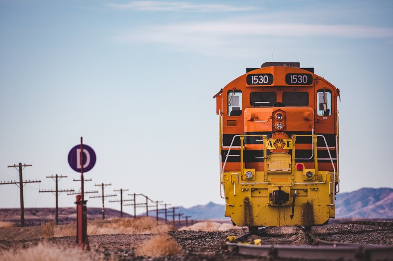 Orange Train on Tracks — Serene, Afternoon