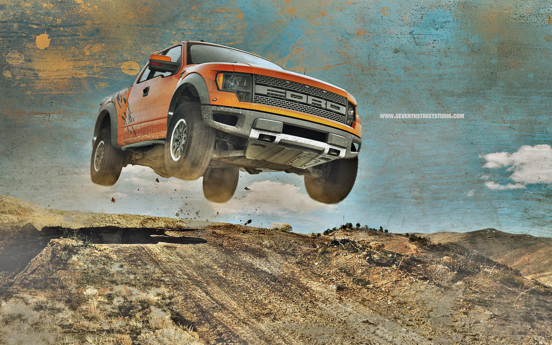 Orange truck jumping over terrain