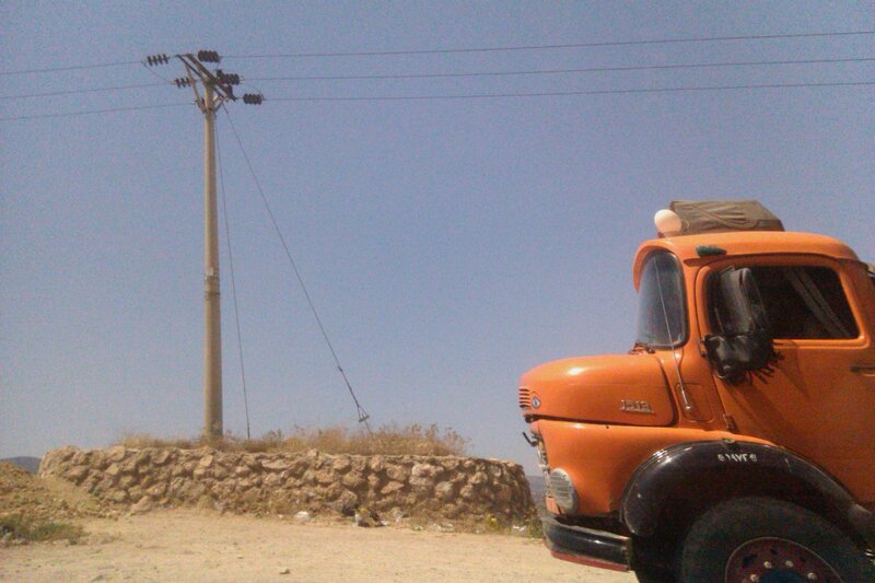 Orange truck near utility pole