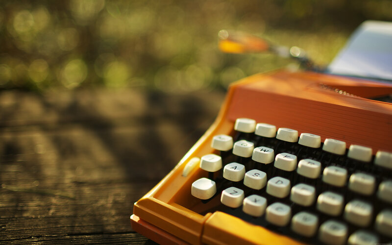 orange typewriter in sunlight