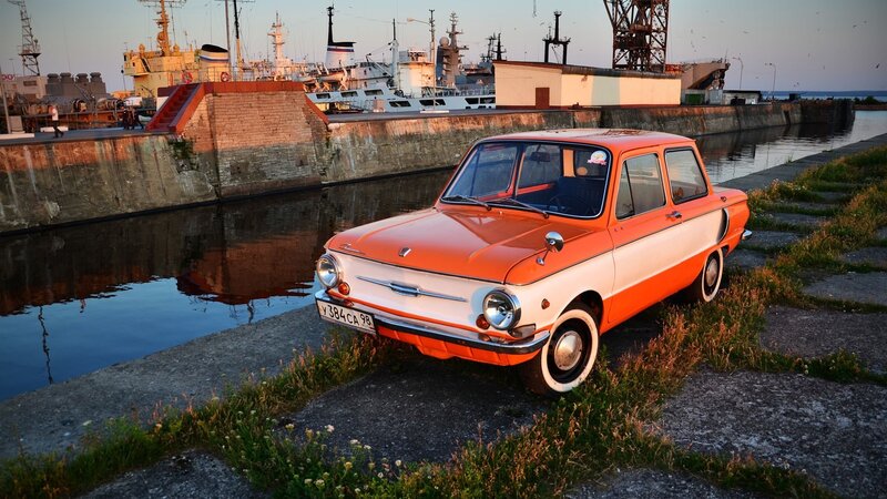 Orange vintage car at harbor