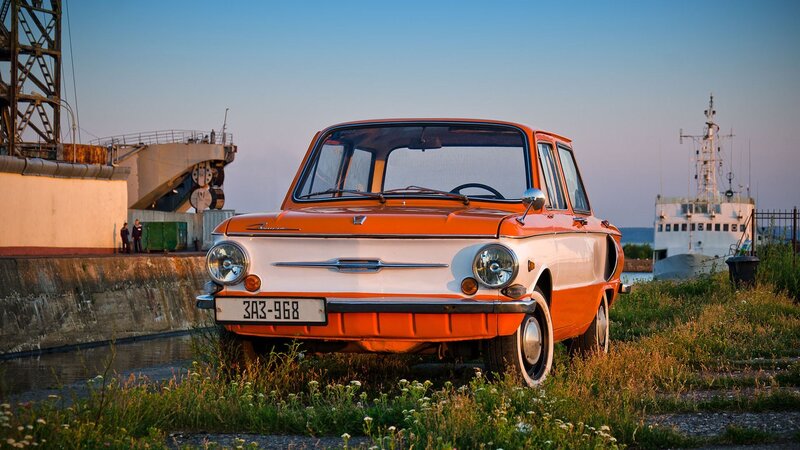 Orange vintage car at port