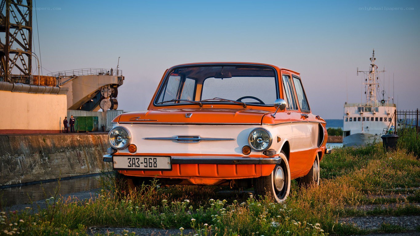 Orange vintage car at port