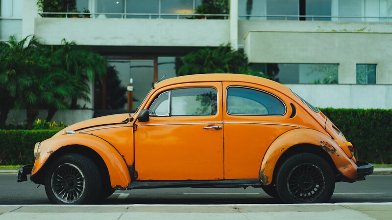 Orange Vintage Car — Calm, Afternoon, Photograph, Building
