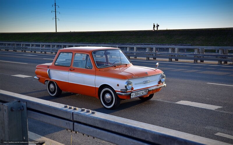 Orange vintage car on highway
