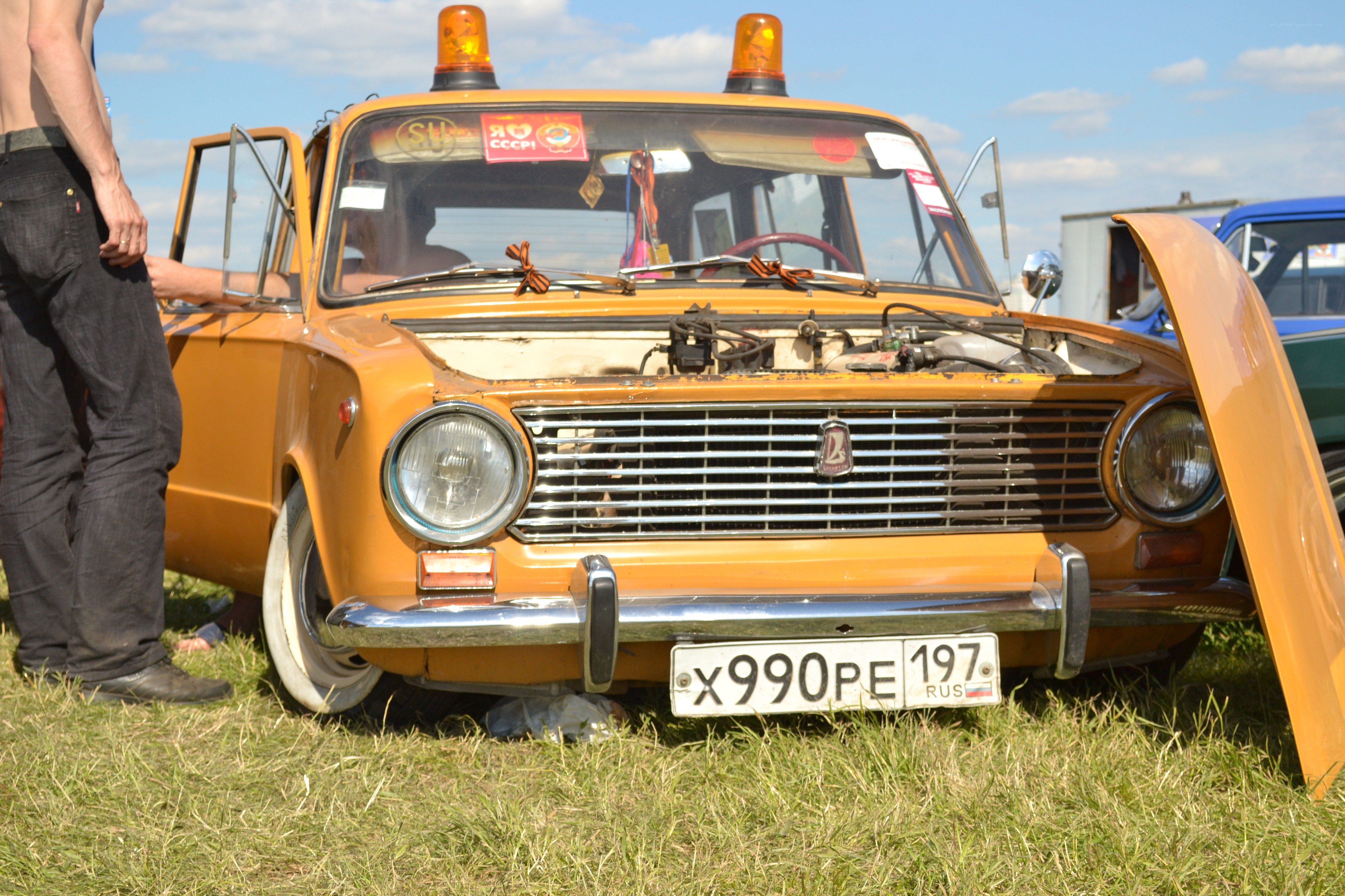 Orange vintage car with open hood
