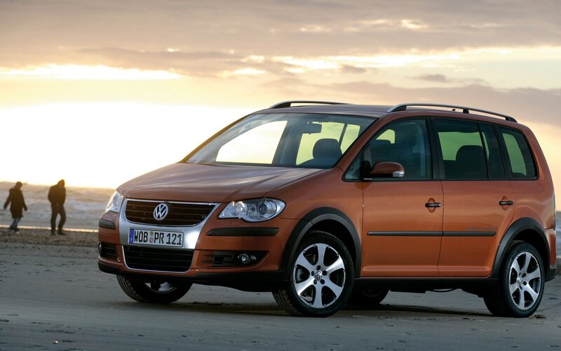 Orange Volkswagen on a beach