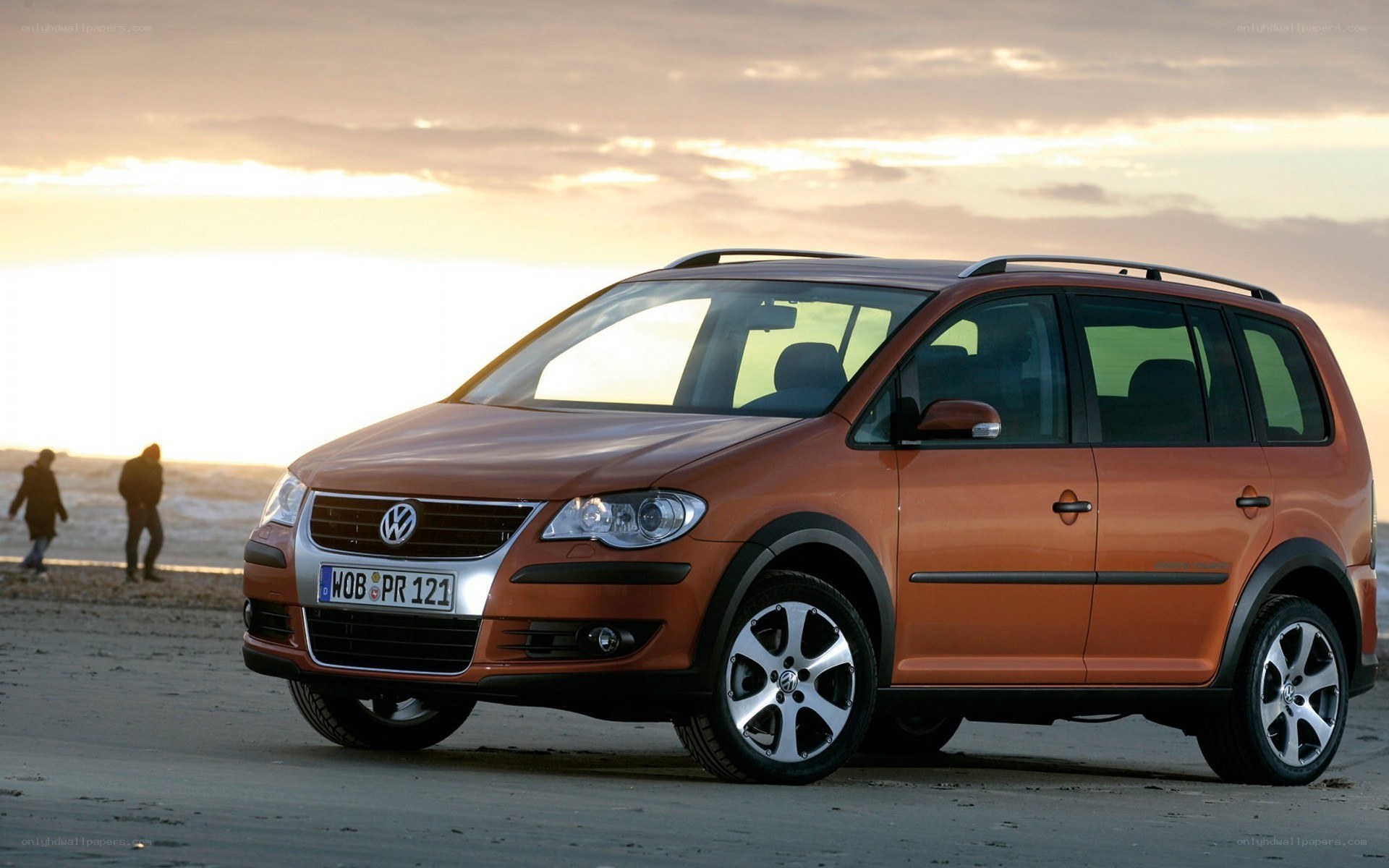 Orange Volkswagen on a beach