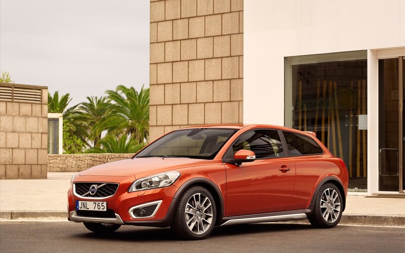 Orange Volvo C30 parked outside building