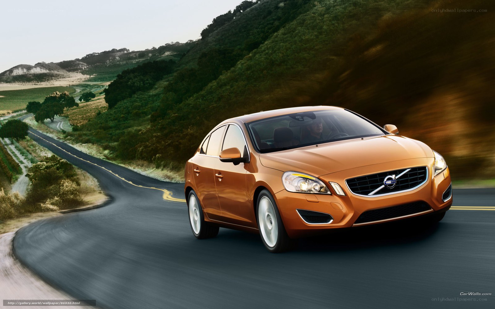 Orange Volvo on winding road