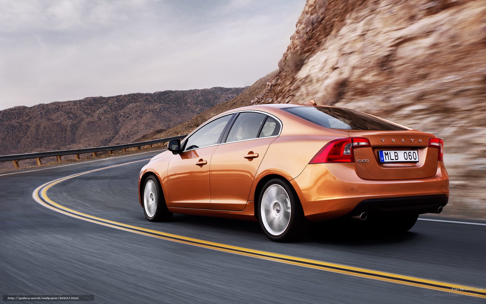 Orange Volvo S60 on winding road